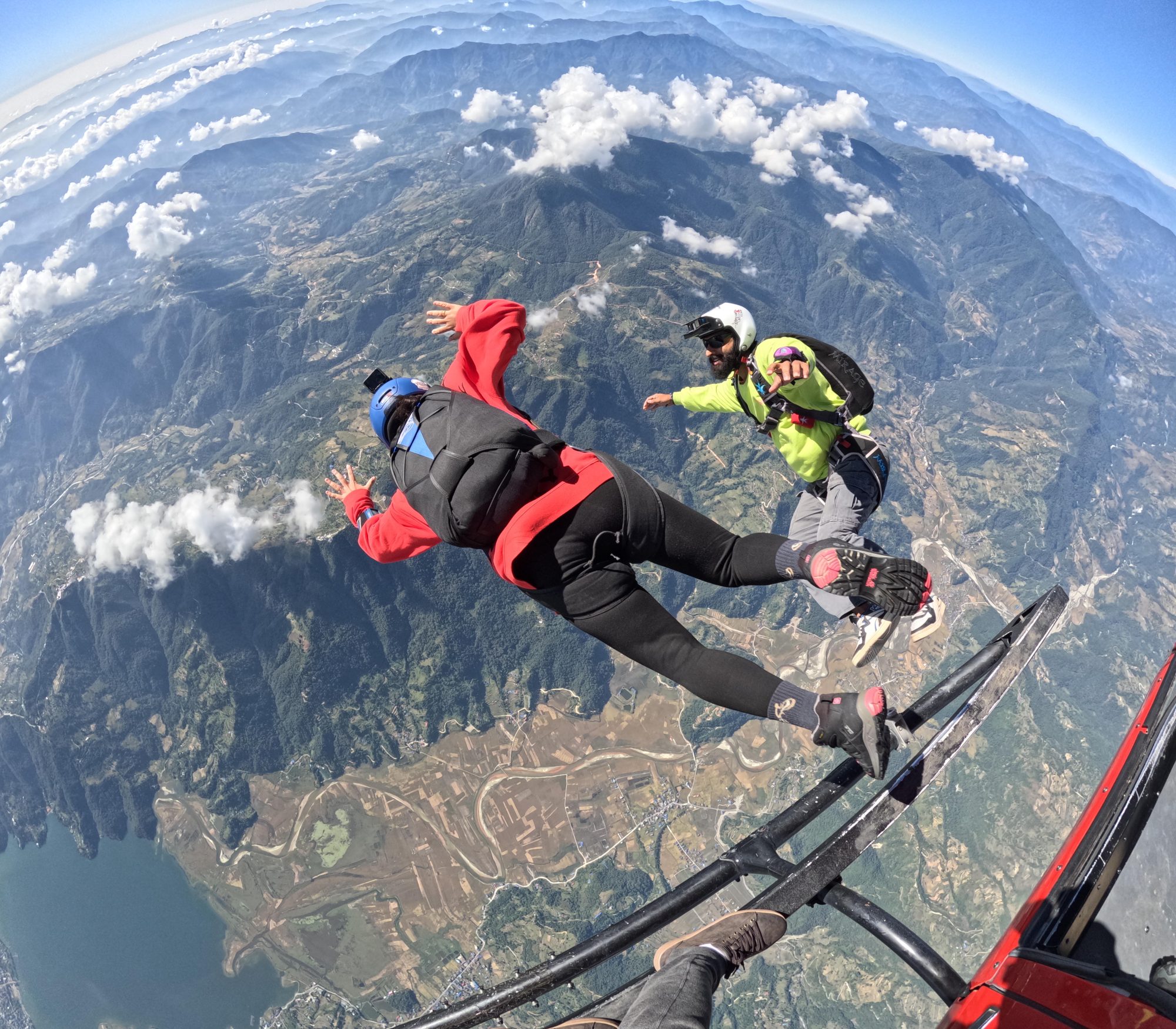 Group of licensed skydivers exiting the aircraft